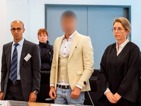 Alaa S., suspected of being responsible for the stabbing of Daniel H. in Chemnitz, his interpreter and lawyer Ricarda Lang arrive at a court in Dresden, Germany, August 22, 2019. (Matthias Rietschel/Pool via REUTERS)