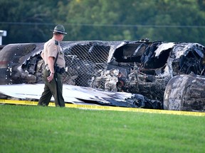 A police officer walks past the wreckage of a plane crash involving NASCAR driver Dale Earnhardt Jr. and his family in Elizabethton, Tennessee, August 15, 2019. (REUTERS/Charles Mostoller)