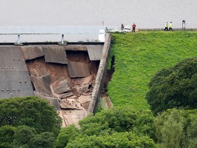 The damage of a dam is seen after a nearby reservoir was affected by flooding, in Whaley Bridge, Britain August 1, 2019. (REUTERS/Phil Noble)