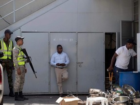 Agents of the Dominican National Drug Control Board (DNCD) and the Prosecutor's Office participate in the dismantling operation of a drug trafficking network, in Santo Domingo, on Tuesday, Aug. 20, 2019.