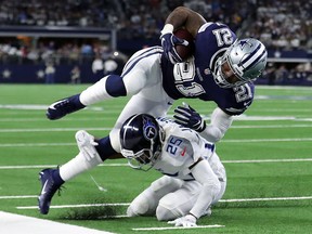 Ezekiel Elliott of the Dallas Cowboys gets knocked out of bounds by Adoree' Jackson of the Tennessee Titans at AT&T Stadium on November 5, 2018 in Arlington. (Tom Pennington/Getty Images)