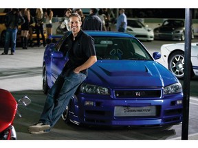 Paul Walker as agent Brian O'Conner leans against his 1998 Nissan Skyline GTR in the ultimate chapter of the franchise built on speed--"Fast  Furious".