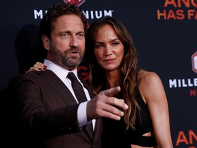 Gerard Butler and Morgan Brown attend the premiere for the film “Angel Has Fallen” in Los Angeles, August 20, 2019. (REUTERS/Mario Anzuoni/File Photo)