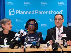 David Eisenberg (R), medical director for Planned Parenthood of the St. Louis Region, Kawanna Shannon (C), director of surgical services, and M'Evie Mead, director of Planned Parenthood Advocates of Missouri (L) speak during a press conference at the Planned Parenthood Reproductive Health Services Center in St. Louis, Missouri, May 31, 2019, the last location in the state performing abortions, after a US Court announced the clinic could continue operating.