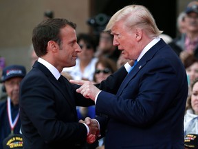 U.S. President Donald Trump (R) talks with French President Emmanuel Macron during a French-US ceremony at the Normandy American Cemetery and Memorial in Colleville-sur-Mer, Normandy, northwestern France, on June 6, 2019, as part of D-Day commemorations marking the 75th anniversary of the World War II Allied landings in Normandy.  IAN LANGSDON/AFP/Getty Images