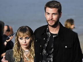 (L-R) Miley Cyrus and Liam Hemsworth attend the Saint Laurent Mens Spring Summer 20 Show on June 6, 2019 in Paradise Cove Malibu, California.