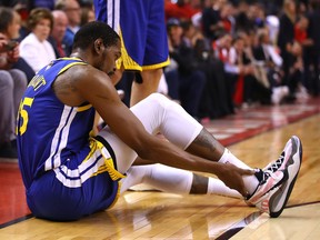 Kevin Durant of the Golden State Warriors reacts after sustaining an injury during the second quarter against the Toronto Raptors during Game Five of the 2019 NBA Finals at Scotiabank Arena on June 10, 2019, in Toronto.