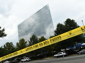 Police and first responders gather at the Gannett Building, home of USA Today, in McLean, Virginia, on August 7, 2019. - The newspaper USA Today evacuated its headquarters in northern Virginia on Wednesday following an alleged sighting of an armed man at the building, but later said the report was "mistaken. Fairfax County police said they had "found no evidence of any acts of violence or injuries."