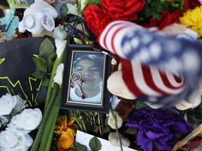 A photo of victim Javier Amir Rodriguez, a 15-year-old sophomore, rests on flowers at a makeshift memorial honoring victims outside Walmart, near the scene of a mass shooting which left at least 22 people dead, on August 7, 2019 in El Paso, Texas. A 21-year-old white male suspect remains in custody in El Paso which sits along the U.S.-Mexico border. President Donald Trump plans to visit the city later today.