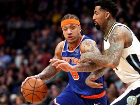 Michael Beasley, left, of the New York Knicks drives to the basket against Wilson Chandler of the Denver Nuggets at the Pepsi Center on Jan. 25, 2018 in Denver, Colorado. (Matthew Stockman/Getty Images)