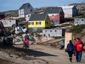 Residents walk in Kulusuk, Greenland on August 16, 2019. (JONATHAN NACKSTRAND/AFP/Getty Images)