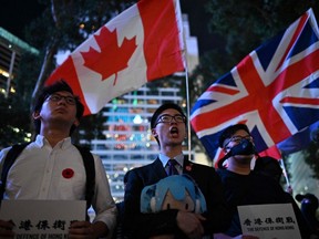 Protesters shout slogans as they attend the Stand in Silence for the 74th Anniversary of the Liberation of Hong Kong gathering at the Cenotaph in Hong Kong, China, on Friday, Aug. 30, 2019.