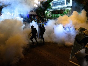 Police fire tear gas during a protest in Tsim Sha Tsui district in Hong Kong on Saturday, Aug. 3, 2019.