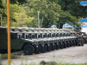 Troops are seen by a row of over a dozen army jeeps at the Shek Kong military base of People's Liberation Army (PLA) in Hong Kong, China August 29, 2019. (REUTERS/Staff)