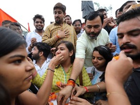 Activists from the Akhil Bharatiya Vidyarthi Parishad (ABVP), the student wing of India's ruling Bharatiya Janata Party (BJP), celebrate after the government scrapped the special status for Kashmir, in New Delhi, India, August 5, 2019.