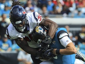 Cody Kessler, bottom, of the Jacksonville Jaguars is tackled by Jadeveon Clowney, top, of the Houston Texans during the second half at TIAA Bank Field on Oct. 21, 2018 in Jacksonville, Fla. (Sam Greenwood/Getty Images)