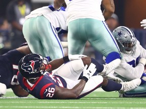 Houston Texans running back Lamar Miller (26) grabs his knee during a play against the Dallas Cowboys at AT&T Stadium. (Matthew Emmons-USA TODAY Sports)
