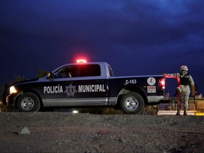 Municipal police officers and members of the Mexican National Guard stand guard near the border between Mexico and U.S., as seen from Ciudad Juarez, Mexico, on July 17, 2019.