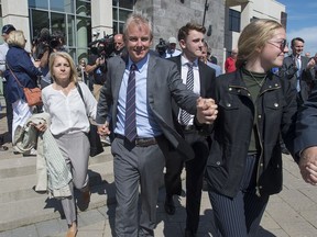 Dennis Oland and family members head from the Law Courts in Saint John, N.B., after he was found not guilty of murdering his father on Friday, July 19, 2019.