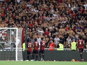 Players speak with supporters as the referee halted the game following homophobic songs and banners during the French L1 match between OGC Nice and Olympique de Marseille on August 28, 2019 at the Allianz Riviera stadium in Nice. (VALERY HACHE/AFP/Getty Images)