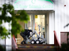 A man operates a police robot near the site of a shooting in al-Noor Islamic centre mosque, near Oslo, Norway, on Saturday, Aug. 10, 2019.