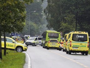 A police car and an ambulance are seen near the site after a shooting in al-Noor Islamic centre mosque, near Oslo, Norway, on Saturday, Aug. 10, 2019.