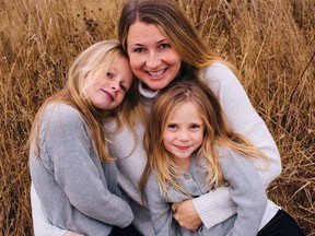 Sarah Cotton holds her daughters Chloe, left, and Aubrey Berry in October 2017 in this handout photo.