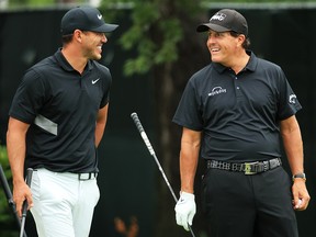 Brooks Koepka and Phil Mickelson talk on the 10th tee during the final round of the BMW Championship at Medinah Country Club No. 3 on August 18, 2019 in Medinah, Illinois. (Andrew Redington/Getty Images)