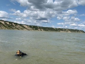 The RCMP Underwater Recovery Team completes their work following the discovery of a boat on the shore of the Nelson River, northeast of Gillam, Man. in this handout photo provided August 5, 2019. RCMP say they will no longer be searching a river in northern Manitoba for two murder suspects.