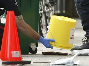 Police investigate a handgun left at the scene of a brazen daylight shooting that left a male dead in front of a Roncesvalles Ave. Italian restaurant in Toronto Friday, Aug. 16 2019