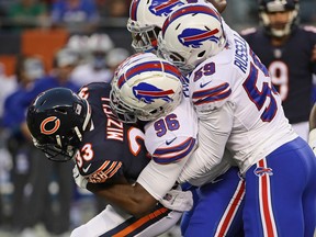 Taquan Mizzell of the Chicago Bears is dropped by Terrence Fede and Ryan Russell  of the Buffalo Bills during a preseason game at Soldier Field on August 30, 2018 in Chicago. (Jonathan Daniel/Getty Images)