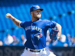 Blue Jays starting pitcher Sean Reid-Foley works against the Texas Rangers on Wednesday in Toronto. Reid-Foley lasted just 3.1 innings and took the loss. (THE CANADIAN PRESS)