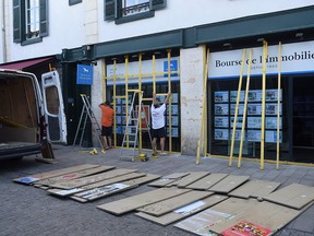 People board up the windows of a real estate agency in Bayonne France on August 23, 2019, ahead of expected protests on the sidelines of the annual G7 summit. (IROZ GAIZKA/AFP/Getty Images)