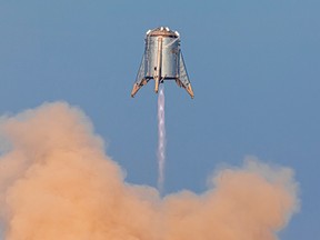 SpaceX's Mars Starship prototype "Starhopper" hovers over its launchpad during a test flight in Boca Chica, Texas, Aug. 27, 2019.