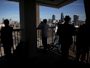 People take in a view from the Tate Modern building in London, England, Oct. 3, 2016.