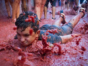 A reveller covered in tomato pulp takes part in the annual "Tomatina" festival in the eastern town of Bunol, on August 28, 2019. (JAIME REINA/AFP/Getty Images)