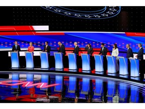 Democratic 2020 U.S. presidential candidates (L-R) U.S. Senator Michael Bennet, U.S. Senator Kirsten Gillibrand, former HUD Secretary Julian Castro, U.S. Senator Cory Booker, former Vice President Joe Biden, U.S. Senator Kamala Harris, entrepreneur Andrew Yang, U.S. Rep. Tulsi Gabbard, Washington Governor Jay Inslee  and New York City Mayor Bill de Blasio pose together before the start of the second night of the second U.S. 2020 presidential Democratic candidates debate in Detroit, Michigan, July 31, 2019.