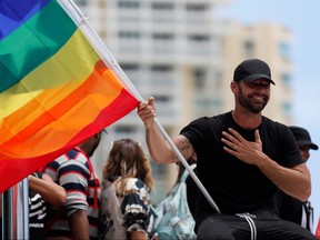Ricky Martin waves a rainbow flag during a protest calling for the resignation of Governor Ricardo Rossello in San Juan, Puerto Rico July 22, 2019.