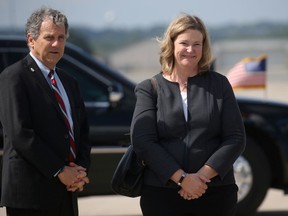 U.S. Senator Sherrod Brown (D-OH)  and Dayton, Ohio Mayor Nan Whaley wait to speak with U.S. President Donald Trump as Trump arrived aboard Air Force One at Wright-Patterson Air Force Base on his way to visit the site of a mass shooting in Dayton, Ohio, U.S., August 7, 2019.