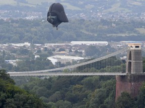 Darth Vader balloon above Clifton Suspension Bridge during the hot air balloons mass ascent at sunrise on the first day of the Bristol International Balloon Fiesta on Aug.8, 2019 in Bristol, England.