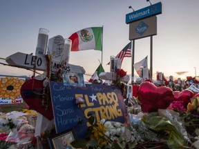 People pray and pay their respects at the makeshift memorial for victims of the shooting that left a total of 22 people dead at the Cielo Vista Mall WalMart in El Paso, Texas, on Tuesday, Aug. 6, 2019.