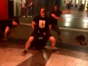 A wrestling fan applies the "Walls of Jericho" to another fan outside the Scotiabank Arena after Monday Night Raw let out. (Twitter)