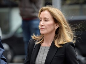 Felicity Huffman is escorted by police into court where she pled guilty to one count of conspiracy to commit mail fraud and honest services mail fraud before Judge Talwani at John Joseph Moakley United States Courthouse in Boston, May 13, 2019.