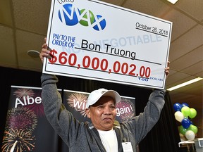 Bon Truong is the winner of the long-awaited $60 million LOTTO MAX jackpot prize from the October 26 draw, here accepting his cheque at the Alberta Gaming, Liquor and Cannabis Office in St. Albert, August 28, 2019. (Ed Kaiser/Postmedia)
