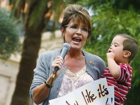Oct. 22, 2010: Politician and conservative activist Sarah Palin holds her son Trig Palin as she speaks during a rally for the Tea Party Express national tour in Phoenix, Ariz.