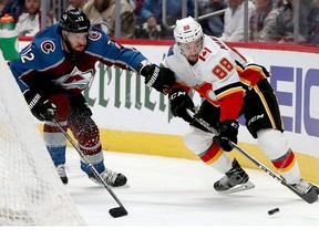 DENVER, COLORADO - APRIL 17: Patrik Nemeth #12 of the Colorado Avalanche fights for the puck against Andrew Mangiapane #88 of the Calgary Flames in the first period during Game Four of the Western Conference First Round during the 2019 NHL Stanley Cup Playoffs at the Pepsi Center on April 17, 2019 in Denver, Colorado.
