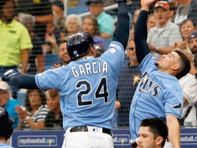 Avisail Garcia, left, of the Tampa Bay Rays and teammate Willy Adames celebrate with a high five after Garcia hit a two-run homer during the bottom of the eighth inning of their game against the Toronto Blue Jays at Tropicana Field on Sept. 8, 2019 in St. Petersburg, Fla. (Joseph Garnett Jr. /Getty Images)