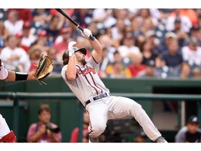 Charlie Culberson #8 of the Atlanta Braves reacts after getting hit by a ball in the seventh inning during a baseball game against the Washington Nationals at Nationals Park on September 14, 2019 in Washington, DC.