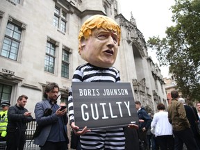 A person dressed as Boris Johnson holds a guilty sign as the Supreme Court building rules that the prorogation of Parliament was unlawful on September 24, 2019 in London, England.  (Photo by Hollie Adams/Getty Images)
