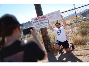 A man poses at an entrance gate to the Nevada Test and Training Range, located near Area 51, on September 20, 2019 near Rachel, Nevada.